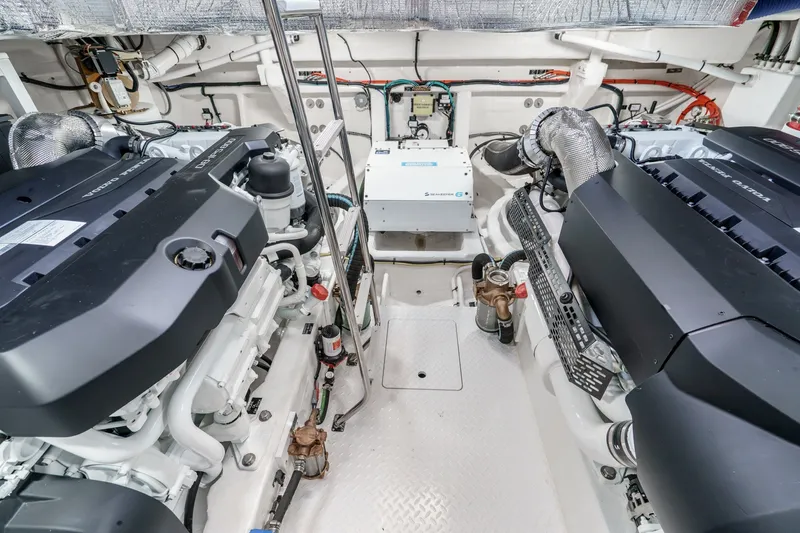 Slide: The Image of Engine room of 2027 Cruisers Yachts 50 Fly, showcasing dual engines and mechanical systems. - 88