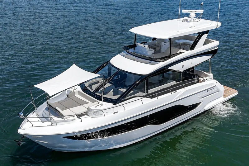 Slide: The Image of 2027 Cruisers Yachts 50 Fly luxury yacht cruising on open water. - 13