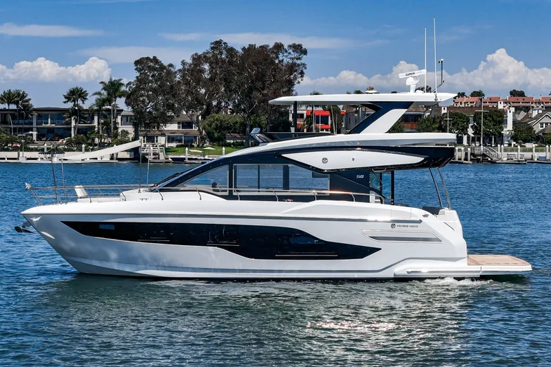 Slide: The Image of Luxurious 2027 Cruisers Yachts 50 Fly on serene water, showcasing sleek design and elegance. - 10