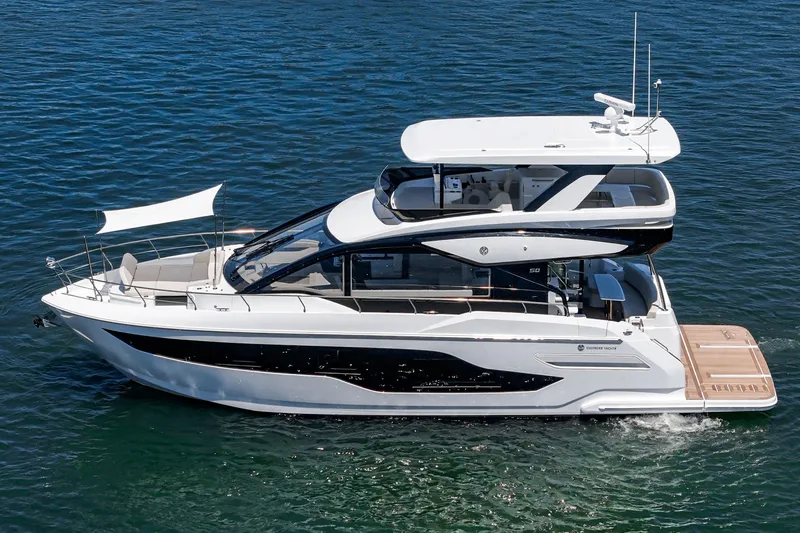 Slide: The Image of 2027 Cruisers Yachts 50 Fly luxury yacht cruising on open water. - 8