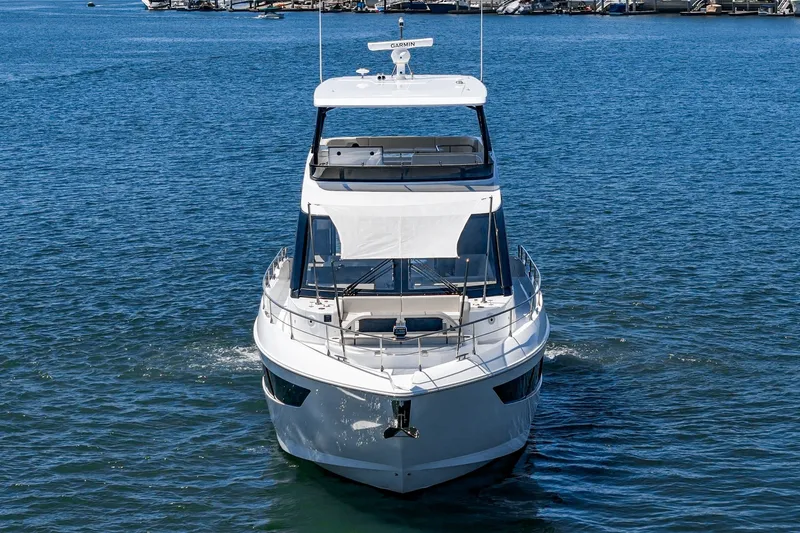 Slide: The Image of 2027 Cruisers Yachts 50 Fly on open water, front view. - 23