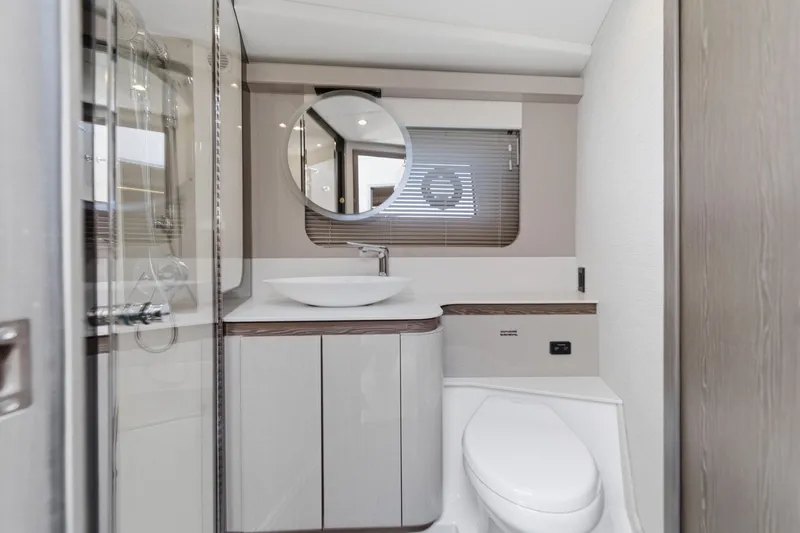Slide: The Image of Luxurious bathroom in 2027 Cruisers Yachts 50 Fly, featuring modern fixtures and elegant design. - 86