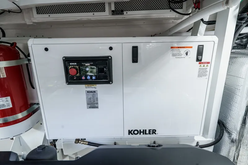 Slide: The Image of Kohler generator in 2027 Cruisers Yachts 50 Fly engine room, with fire extinguisher nearby. - 95