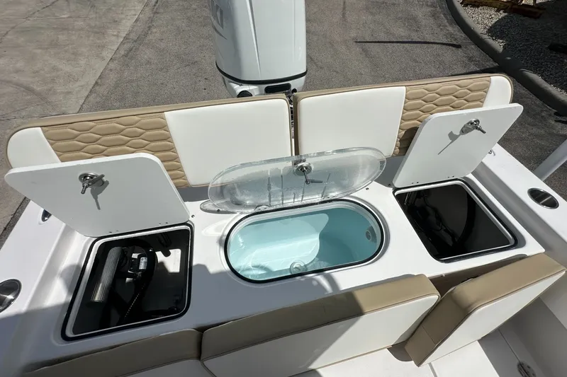 Slide: The Image of 2026 Twin Vee 22 BayCat boat interior with storage compartments and seating. - 14