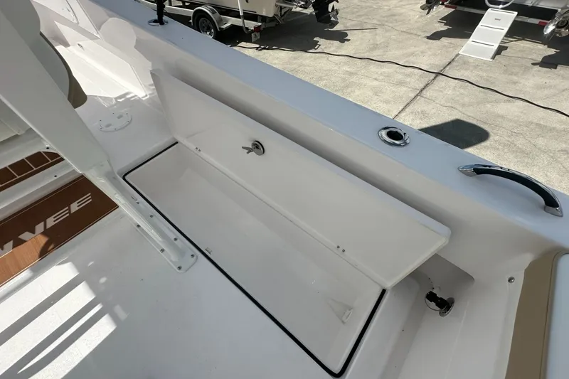 Slide: The Image of 2026 Twin Vee 22 BayCat boat interior with open storage compartment. - 15