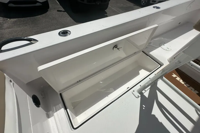 Slide: The Image of 2026 Twin Vee 22 BayCat boat storage compartment open, showcasing interior space. - 16