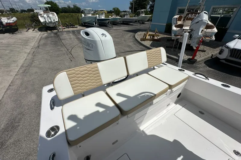 Slide: The Image of 2026 Twin Vee 22 BayCat boat with cushioned seating and Suzuki outboard motor. - 13