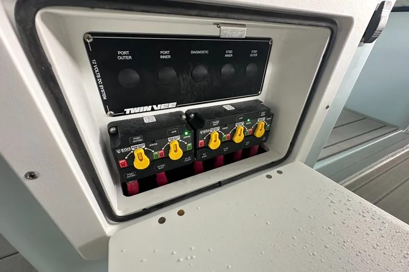 Slide: The Image of Control panel of 2025 Twin Vee 400 GFX2 CC boat with labeled switches. - 26