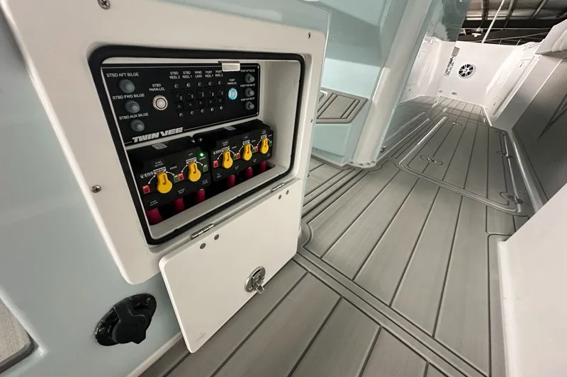 Slide: The Image of 2025 Twin Vee 400 GFX2 CC boat interior with control panel and sleek flooring. - 19
