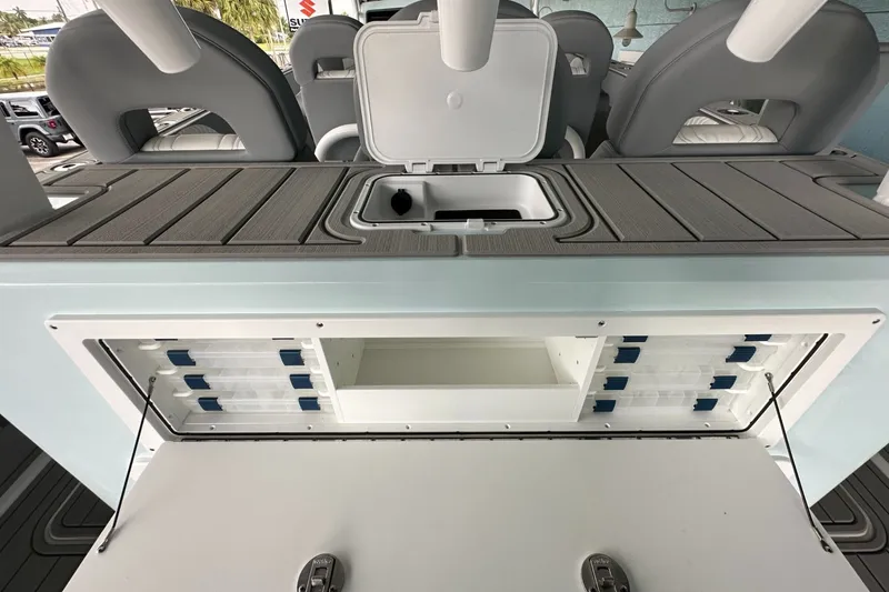 Slide: The Image of 2025 Twin Vee 400 GFX2 CC boat interior with storage compartments and seating. - 22