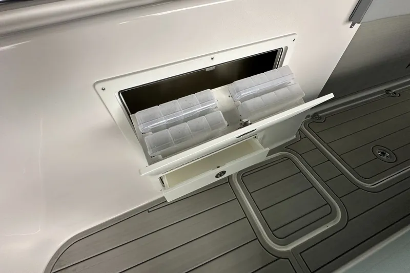 Slide: The Image of Storage compartment on 2025 Twin Vee 400 GFX2 CC boat with organized tackle boxes. - 32