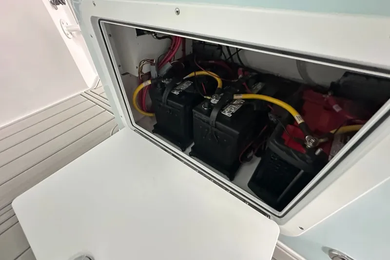 Slide: The Image of Battery compartment of 2025 Twin Vee 400 GFX2 CC boat, showing wiring and connections. - 27