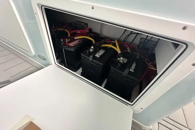 Slide: The Image of Battery compartment of 2025 Twin Vee 400 GFX2 CC boat, featuring multiple batteries. - 28