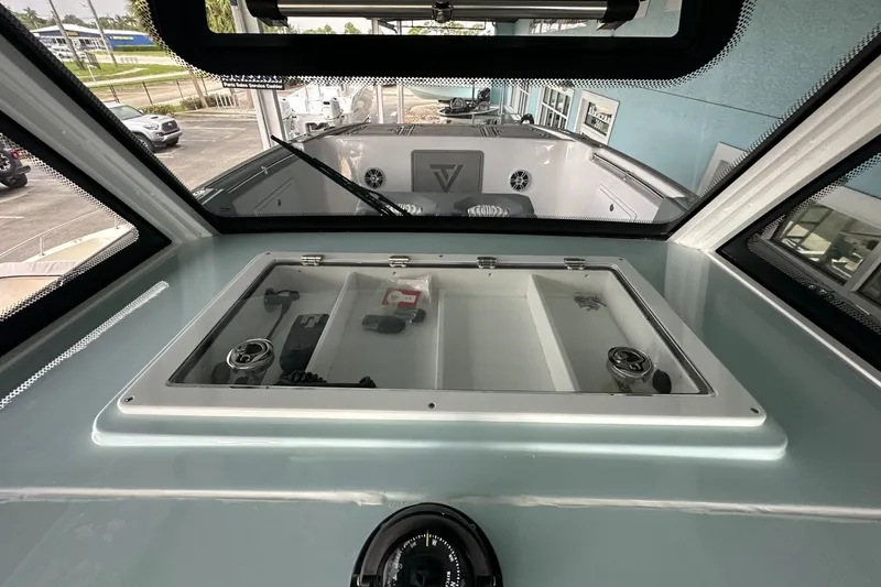 Slide: The Image of 2025 Twin Vee 400 GFX2 CC boat interior with storage compartment and modern design. - 44