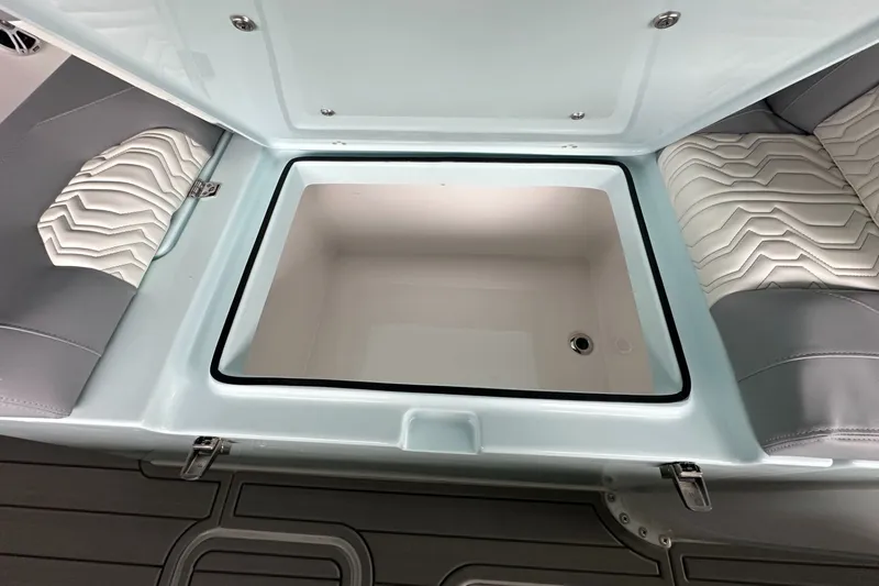 Slide: The Image of Open storage compartment on 2025 Twin Vee 400 GFX2 CC boat with cushioned seating. - 40