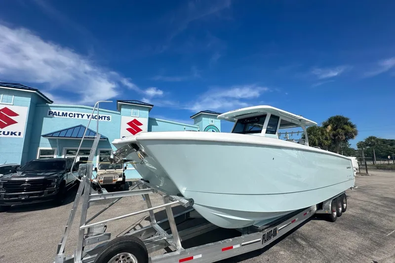 Slide: The Image of 2025 Twin Vee 400 GFX2 CC boat on trailer at Palm City Yachts dealership. - 2