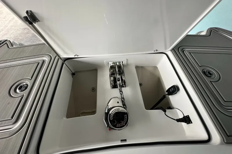 Slide: The Image of Anchor compartment of 2025 Twin Vee 400 GFX2 CC boat, featuring storage and winch system. - 35