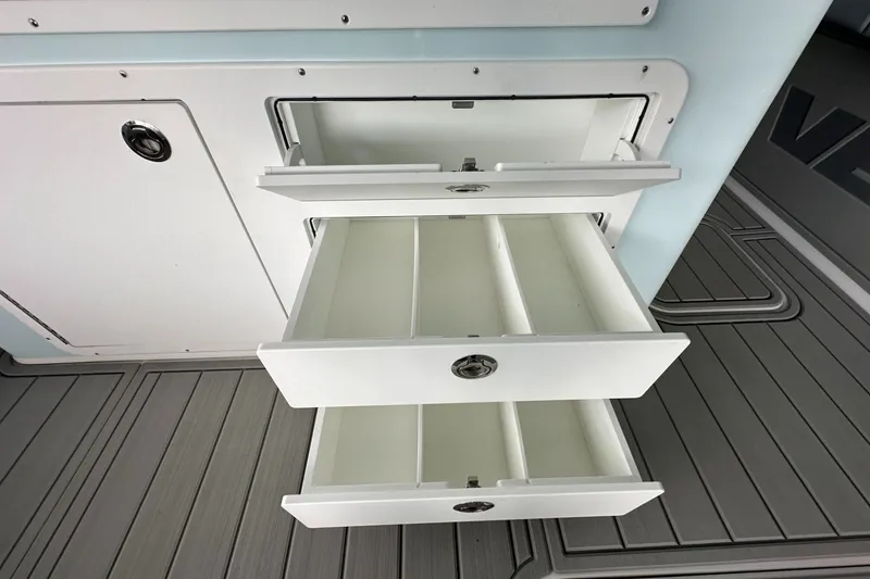 Slide: The Image of Open storage drawers on 2025 Twin Vee 400 GFX2 CC boat, showcasing interior compartments. - 20