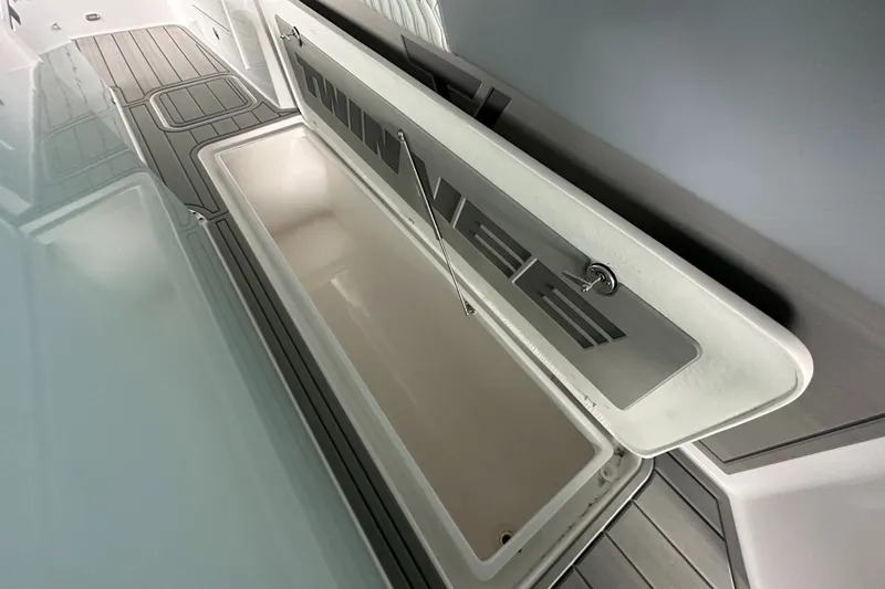 Slide: The Image of Open storage compartment on 2025 Twin Vee 400 GFX2 CC boat deck. - 31