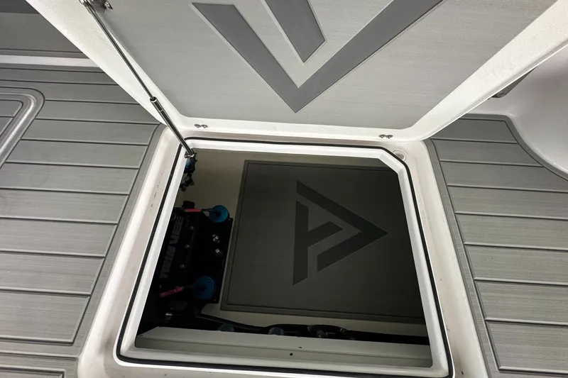 Slide: The Image of 2025 Twin Vee 400 GFX2 CC boat storage compartment with logo detail. - 16