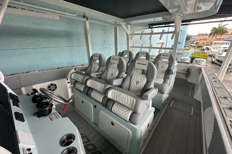 Slide: The Image of 2025 Twin Vee 400 GFX2 CC boat interior with luxury seating and modern controls. - 29