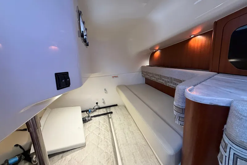 Slide: The Image of 2023 Pursuit OS 385 Offshore cabin interior with modern seating and ambient lighting. - 51