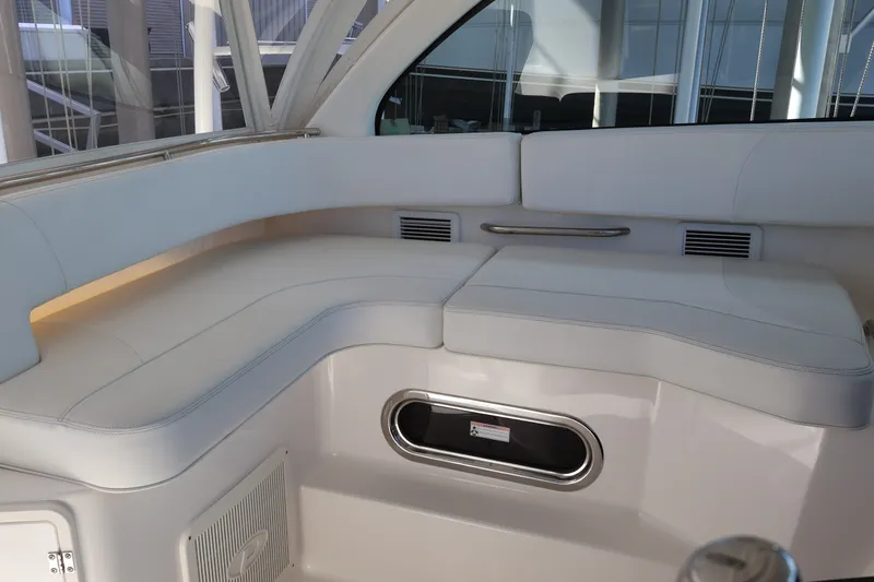 Slide: The Image of 2023 Pursuit OS 385 Offshore boat interior with white cushioned seating. - 32