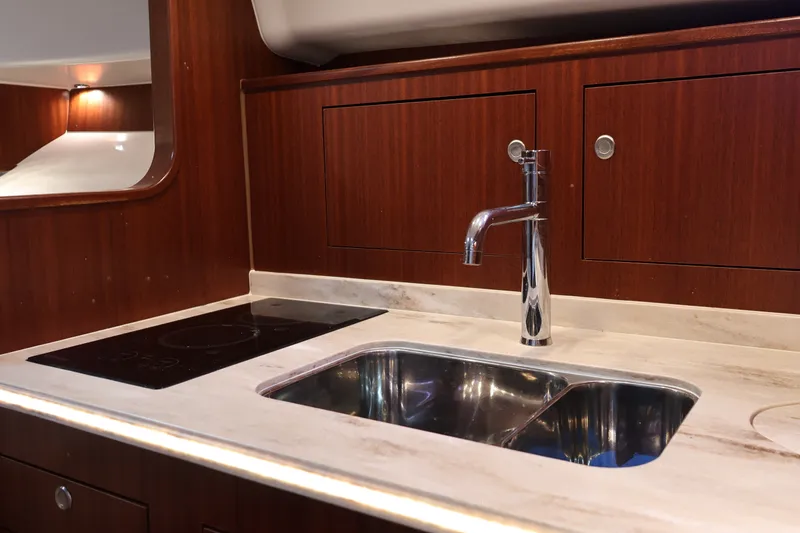 Slide: The Image of Luxurious kitchen area in 2023 Pursuit OS 385 Offshore yacht with modern sink and stove. - 40
