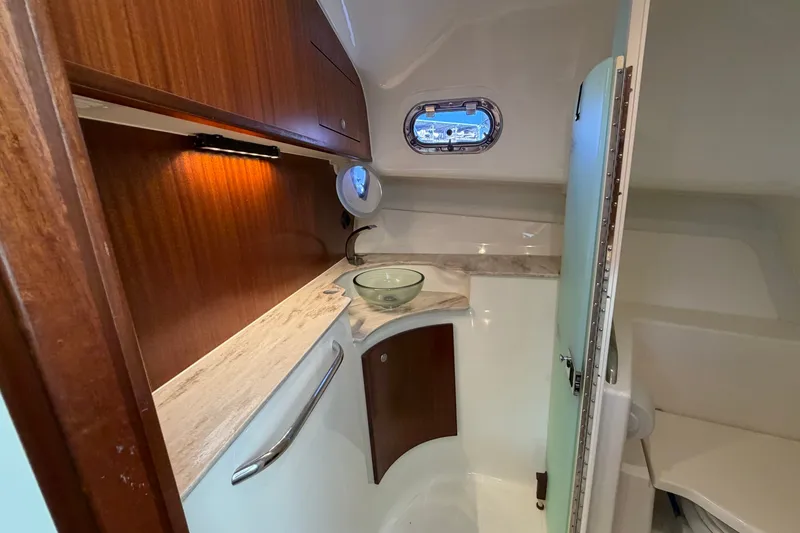 Slide: The Image of 2023 Pursuit OS 385 Offshore yacht interior with wooden cabinetry and modern sink. - 48