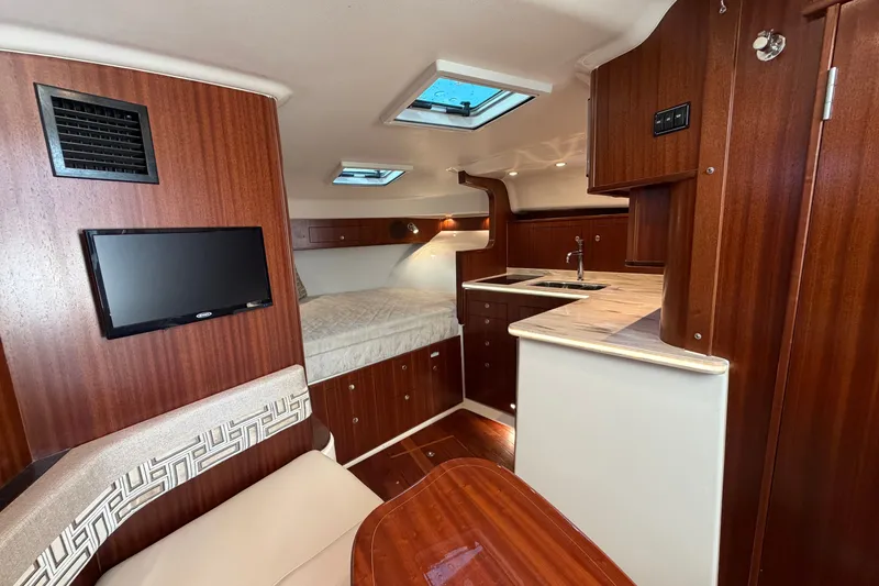 Slide: The Image of Luxurious interior of 2023 Pursuit OS 385 Offshore boat with wood finish and modern amenities. - 35