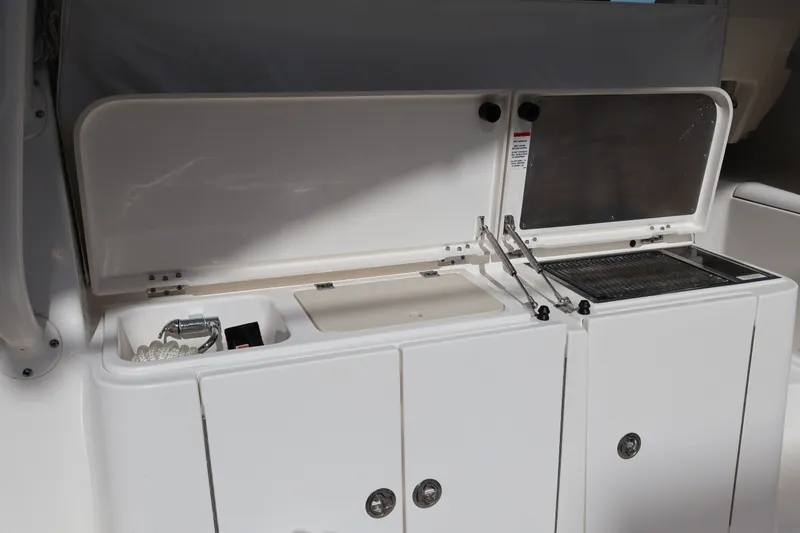 Slide: The Image of 2023 Pursuit OS 385 Offshore boat interior with open storage compartments. - 24