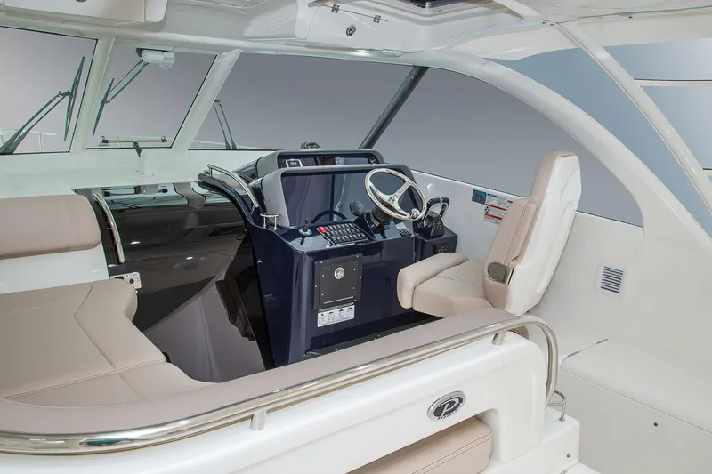 Slide: The Image of Manufacturer Provided Image: 2023 Pursuit OS 385 Offshore boat interior with helm station and seating. - 3