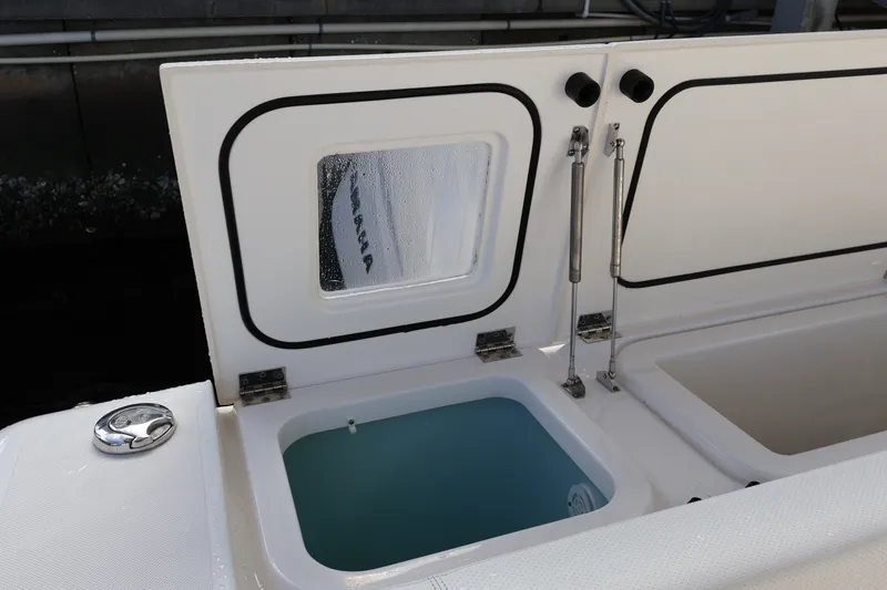 Slide: The Image of 2023 Pursuit OS 385 Offshore boat with open storage compartment and hydraulic hinges. - 17