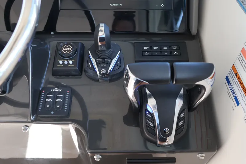 Slide: The Image of Control panel of 2023 Pursuit OS 385 Offshore boat with throttle and navigation controls. - 30