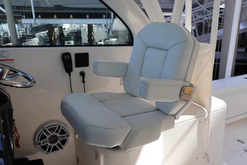 Slide: The Image of Captain's chair on 2023 Pursuit OS 385 Offshore boat, featuring sleek design and comfort. - 33