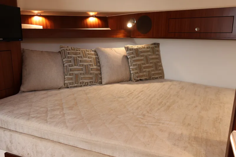 Slide: The Image of Luxurious cabin interior of 2023 Pursuit OS 385 Offshore boat with cozy bedding. - 42