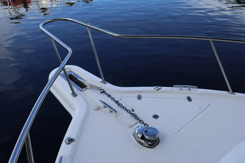 Slide: The Image of Bow of 2023 Pursuit OS 385 Offshore boat with anchor chain and railing. - 54