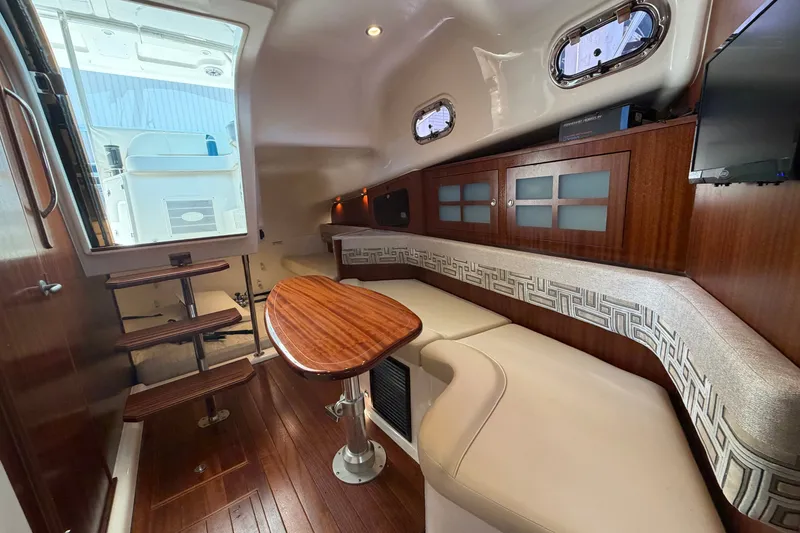 Slide: The Image of Luxurious interior of 2023 Pursuit OS 385 Offshore boat with wooden accents and seating. - 45