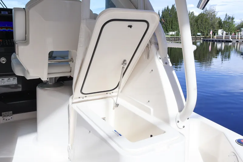 Slide: The Image of 2023 Pursuit OS 385 Offshore boat interior with open storage compartment. - 25