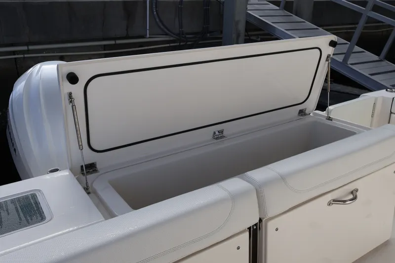 Slide: The Image of 2023 Pursuit OS 385 Offshore boat storage compartment open, showcasing spacious interior. - 18