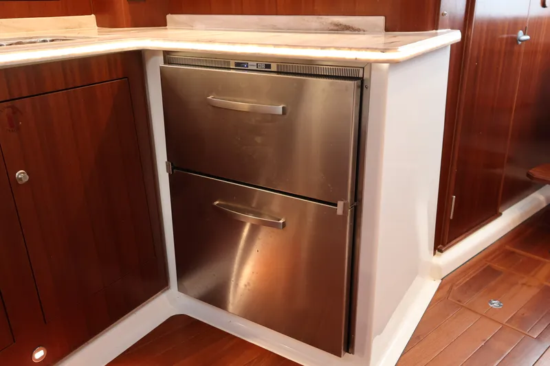 Slide: The Image of 2023 Pursuit OS 385 Offshore yacht kitchen with stainless steel drawers and wood cabinetry. - 41