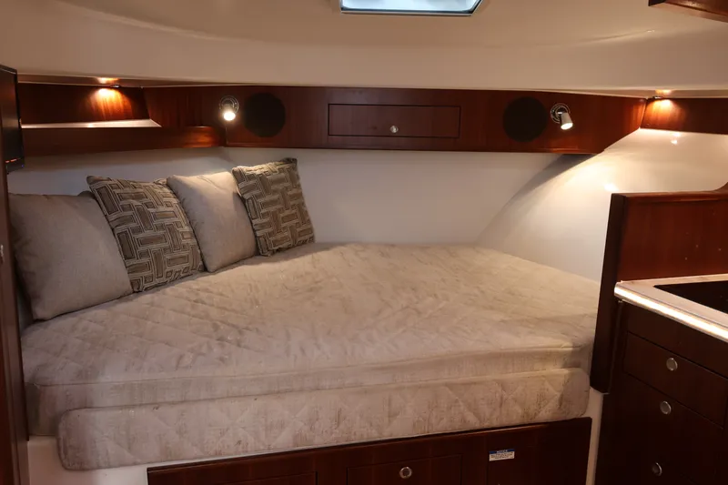 Slide: The Image of Luxurious cabin interior of 2023 Pursuit OS 385 Offshore boat with cozy bedding. - 43