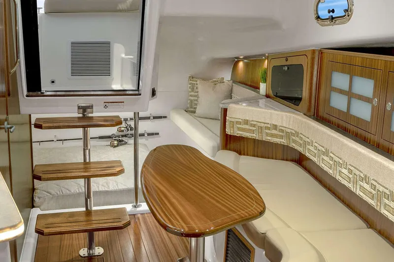 Slide: The Image of Manufacturer Provided Image: 2023 Pursuit OS 385 Offshore cabin interior with wooden finishes and modern seating. - 5