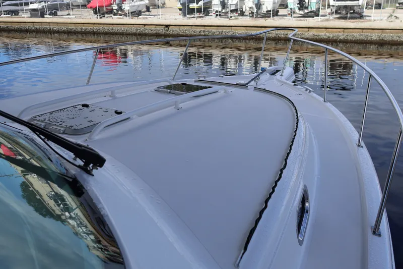 Slide: The Image of 2023 Pursuit OS 385 Offshore boat deck with railing, docked by the water. - 52