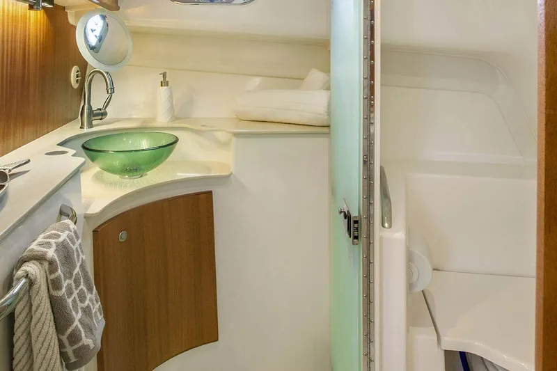 Slide: The Image of Manufacturer Provided Image: 2023 Pursuit OS 385 Offshore boat bathroom with modern sink and shower. - 8