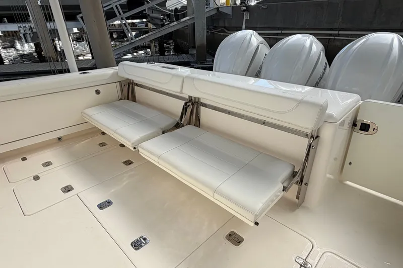 Slide: The Image of 2023 Pursuit OS 385 Offshore boat with foldable seating and triple outboard engines. - 15