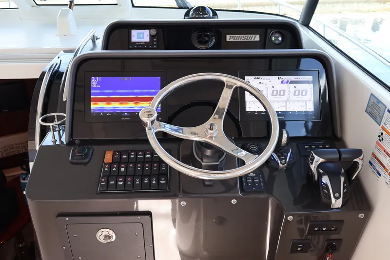 Slide: The Image of 2023 Pursuit OS 385 Offshore helm with advanced navigation displays and controls. - 28