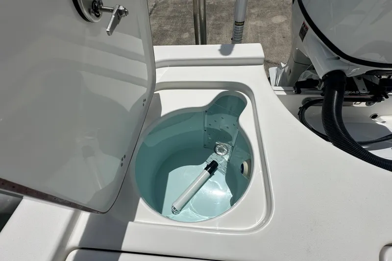 Slide: The Image of Livewell compartment on a 2026 Sea Pro 230 Bay boat, open lid, showing interior details. - 19