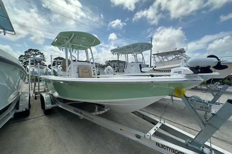 Slide: The Image of 2026 Sea Pro 230 Bay boat on trailer under cloudy sky. - 1