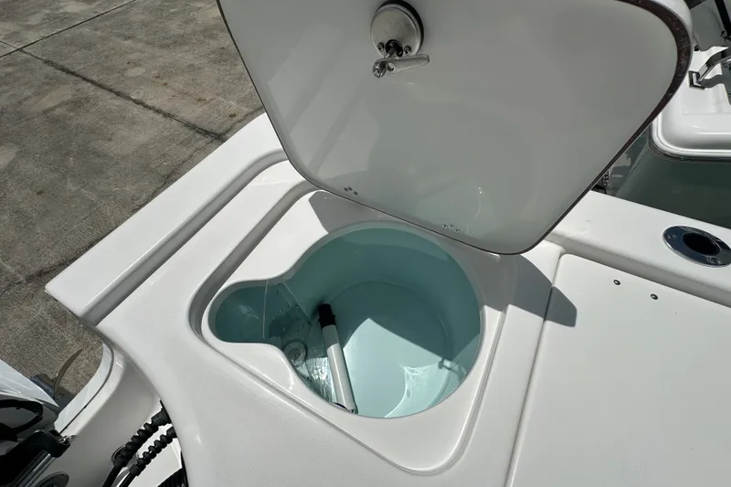 Slide: The Image of Livewell compartment on a 2026 Sea Pro 230 Bay boat, open lid showing interior. - 20